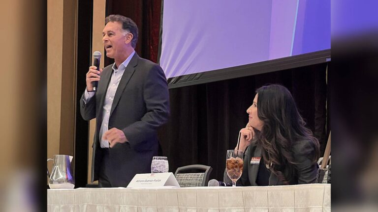 Nevada GOP House candidate Marty ODonnell speaking into a microphone at an event table