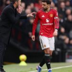 Michael Carrick talking to Bruno Fernandes on the football pitch during a match