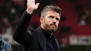 Michael Carrick waving to supporters during a match at Old Trafford