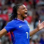 Michael Olise celebrating passionately in a blue France national team jersey