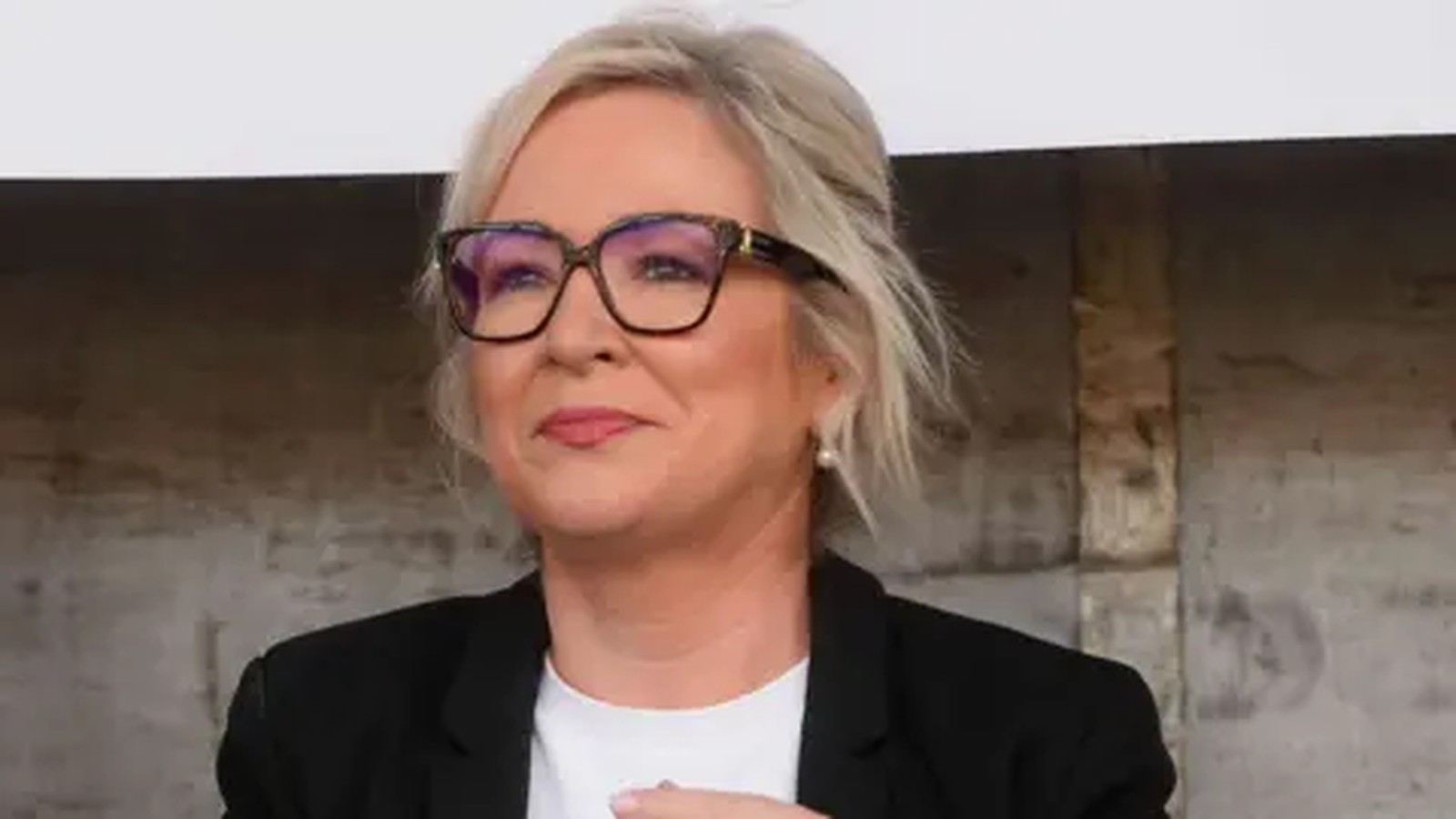 First Minister Michelle ONeill wearing glasses and a black blazer speaking outdoors