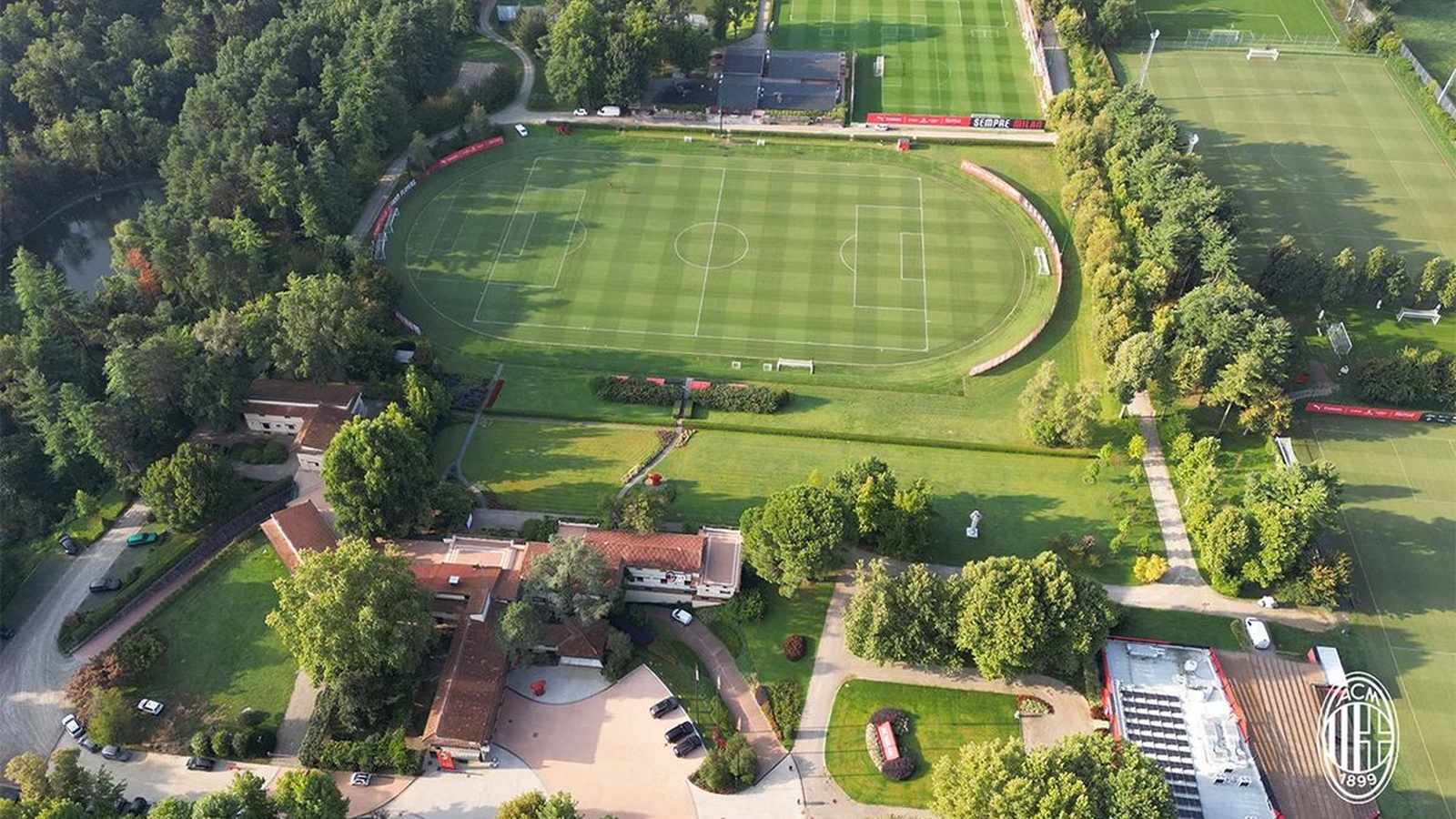 Aerial view of the lush green fields and buildings of Milanello training center