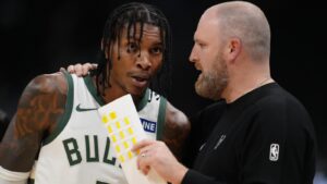 A Milwaukee Bucks player and coach discussing strategy during a basketball game