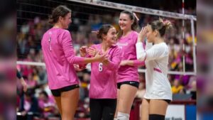 Minnesota Golden Gophers volleyball players celebrate on the court during a match