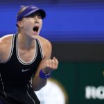 Mirra Andreeva cheering and clenching her fist during a tennis match on court