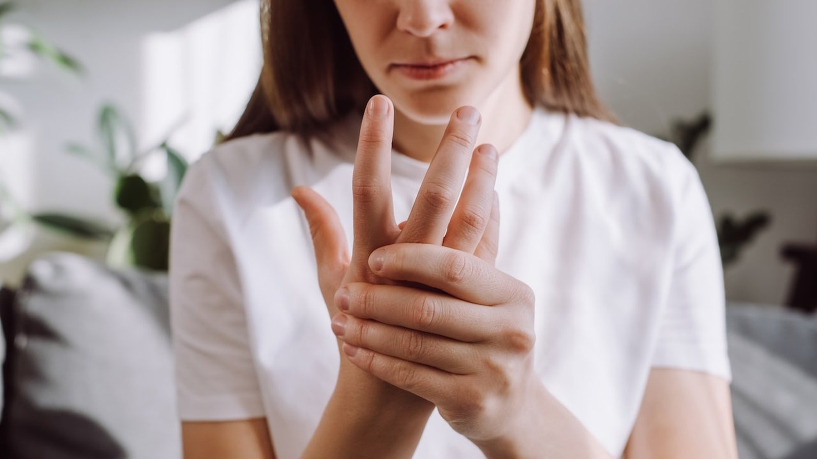 Close-up of a person holding their hand demonstrating a tremor symptom associated with Parkinsons di