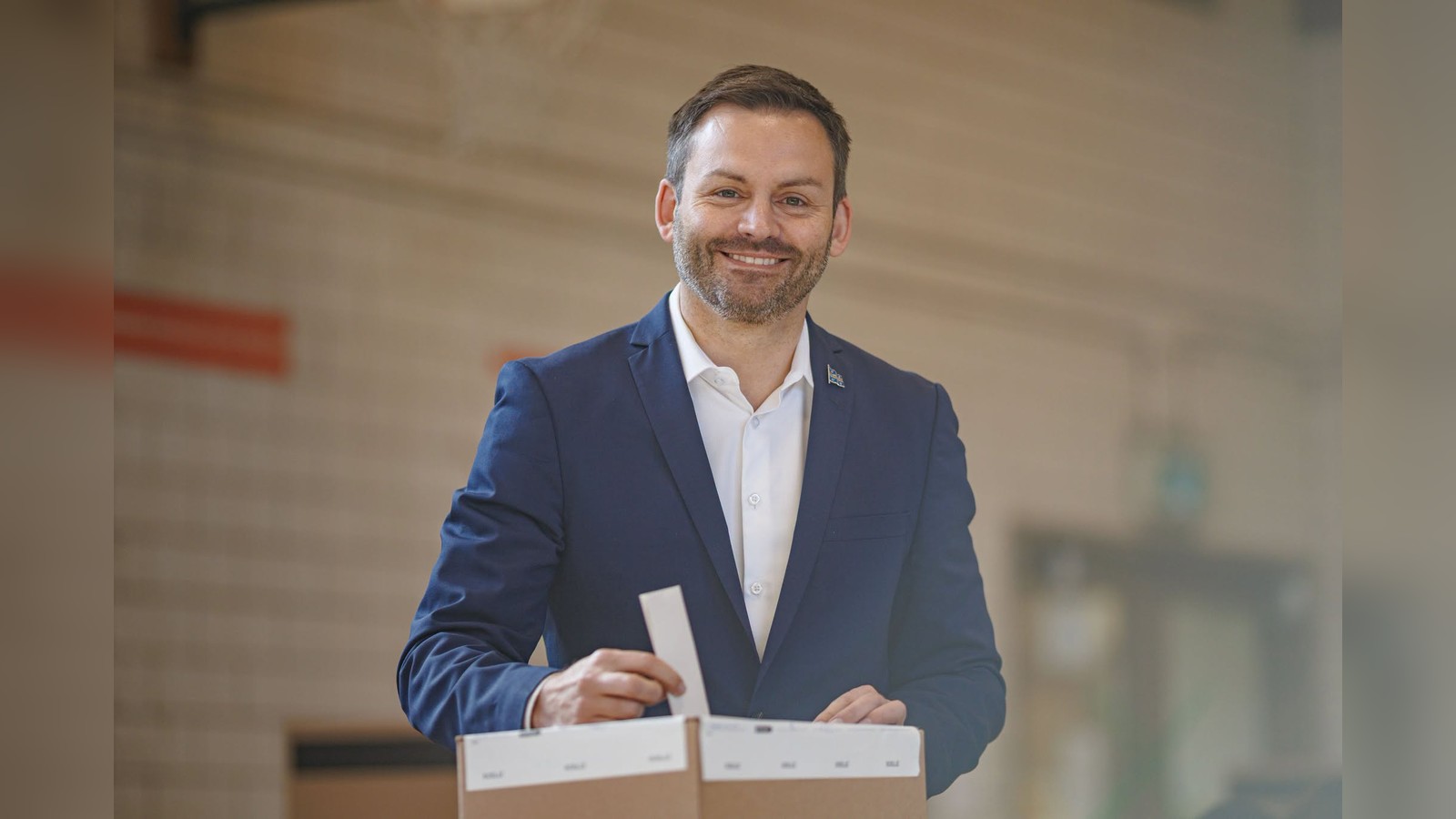 Paul St-Pierre Plamondon smiling while casting a ballot in a voting box