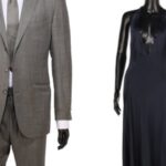 Mannequins displaying a grey Tom Ford suit and a black dress from James Bond films