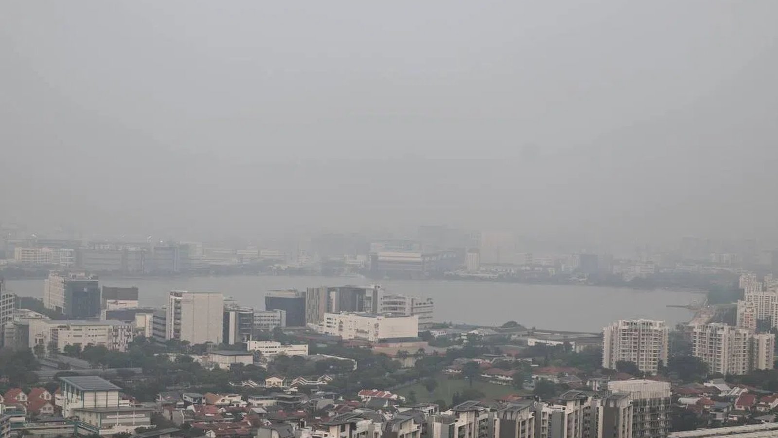 Aerial view of Singapore cityscape obscured by thick haze and poor air quality