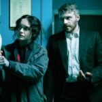A woman holding a bowling pin next to a man in a suit in Slow Horses