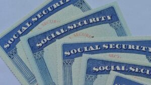 Close-up of multiple blue Social Security cards arranged on a flat surface