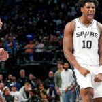 San Antonio Spurs players celebrating enthusiastically during a basketball game on the court