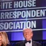 Donald Trump and Melania Trump standing in front of a White House Correspondents Association backdro