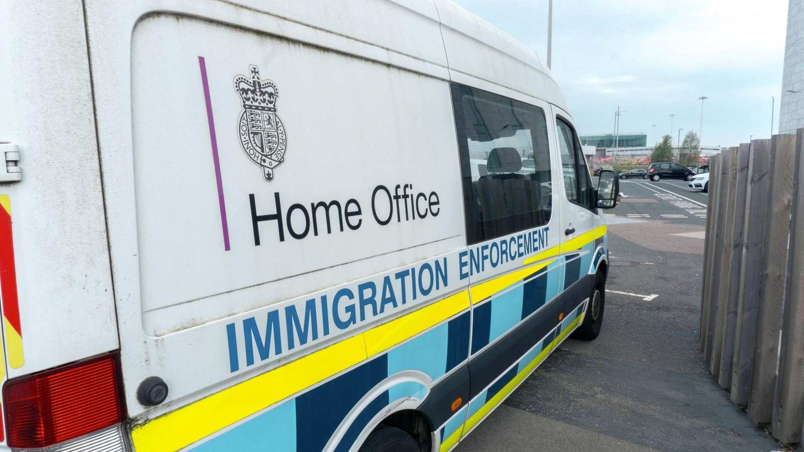 A white Home Office Immigration Enforcement van parked outdoors during an operation