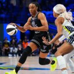 Two WNBA players competing intensely on the basketball court during a playoff game