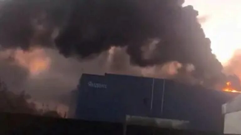 Thick black smoke and fire rising behind a blue Yandex building in Vladimir Russia